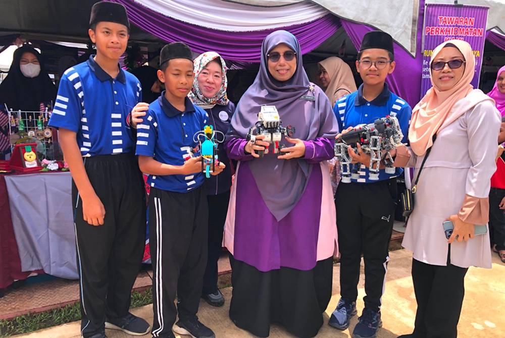 Siti Zailah (tiga dari kanan) menunjukkan robot yang dicipta oleh pelajar Sekolah Menengah Kebangsaan (SMK) Kubang Bemban, Pasir Mas.