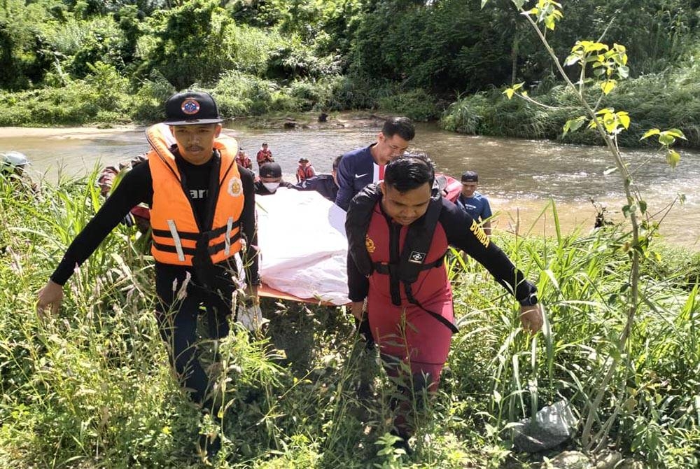 Pasukan bomba mengangkat mayat mangsa yang berjaya ditemui di Taiping. - Foto: Ihsan Bomba