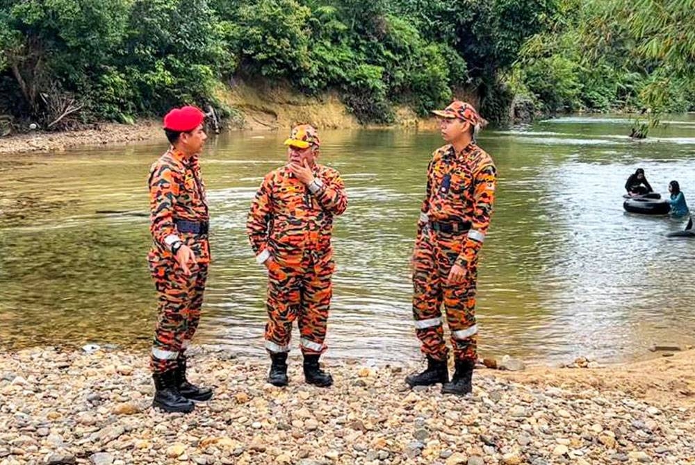 Md Hilman (tengah) meninjau keadaan di Lata Ulu Kasar, di Setiu yang dilanda kepala air pada Jumaat.