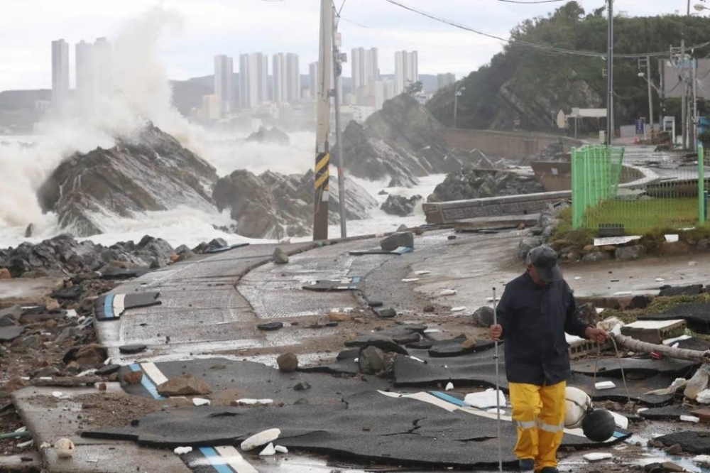 Seorang lelaki berjalan dekat kerosakan yang terjadi akibat Taufan Hinnamnor di Ulsan pada Selasa. - Foto Yomhap/Reuters
