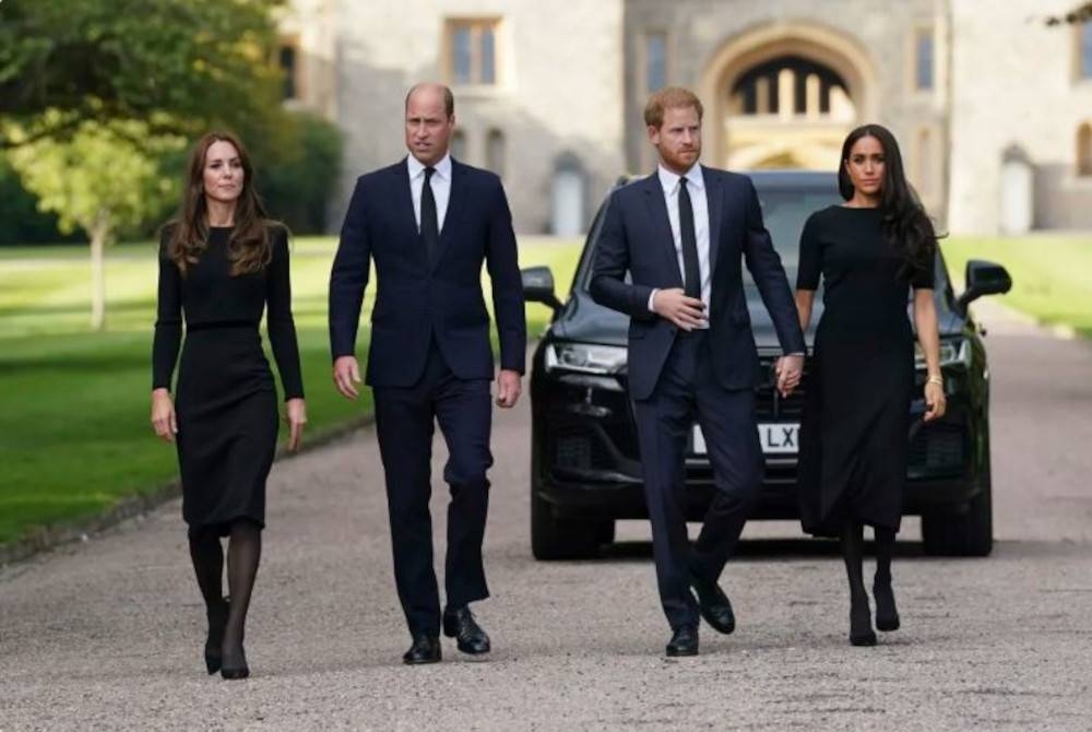 Putera William dan Putera Harry bersama isteri mereka bersama-sama hadir di luar pekarangan Istana Windsor di London untuk melihat jambangan bunga yang ditinggalkan orang ramai sebagai penghormatan atas kemangkatan Ratu Elizabeth II. - Foto AP