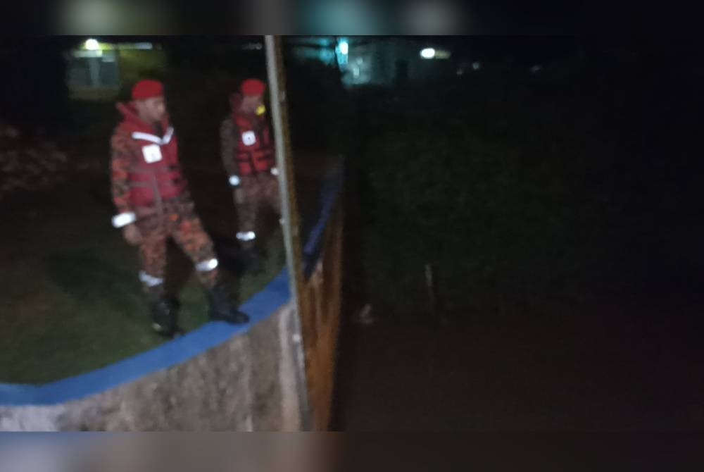 Anggota bomba melakukan pemantaun paras air di Kuala Sungai Pontian Besar pada malam Ahad.