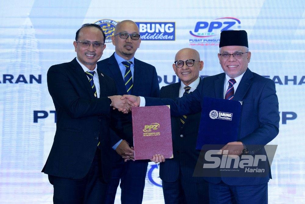 Ahmad Dasuki (kiri) dan Abdul Hakim (kanan) bertukar dokumen perjanjian pada Majlis Pertukaran Memorandum Persefahaman (MoU) antara PTPTN dan PPZ-MAIWP di Menara PTPTN pada Isnin. Turut menyaksikan Pengerusi PTPTN, Apli Yusoff (dua dari kiri) dan Abdul Aziz. - Foto: Sinar Harian/ MOHD HALIM ABDUL WAHID