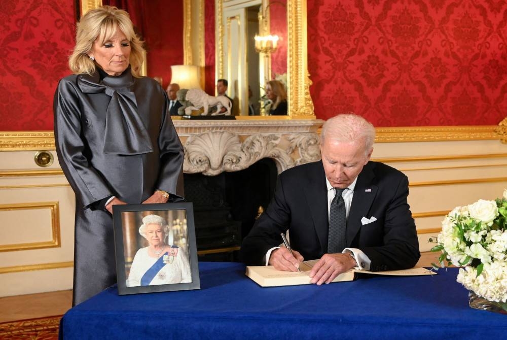 Biden ditemani isteri menandatangani buku takziah atas kemangkatan Ratu Elizabeth II di Lancaster House di London pada Ahad. - Foto Reuters