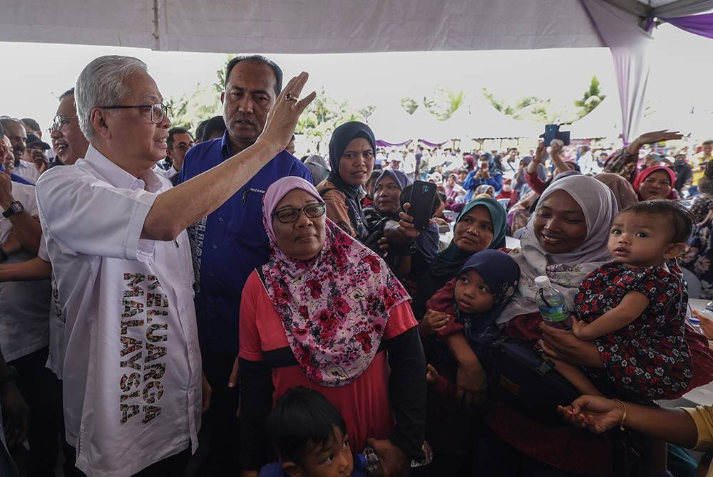 Ismail Sabri beramah mesra bersama penduduk Felda Palong ketika hadir pada Kenduri Sekampung Keluarga Malaysia sempena Jelajah Aspirasi Keluarga Malaysia (AKM) di Felda Palong pada Sabtu. - Foto: Bernama