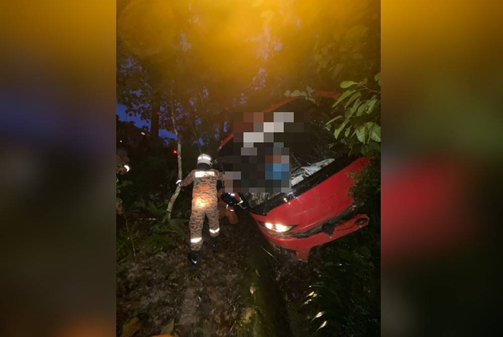 Pasukan bomba menjalankan operasi mengeluarkan mangsa yang tersepit dalam bas terbabit. - Foto ihsan pembaca