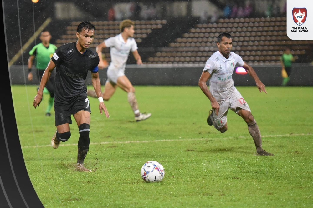 Aksi pemain Sabah FC, Baddrol Bakhtiar (kiri) ketika perlawanan menentang Kuching City di Stadium Likas pada Jumaat. FOTO: Malaysian Football League.