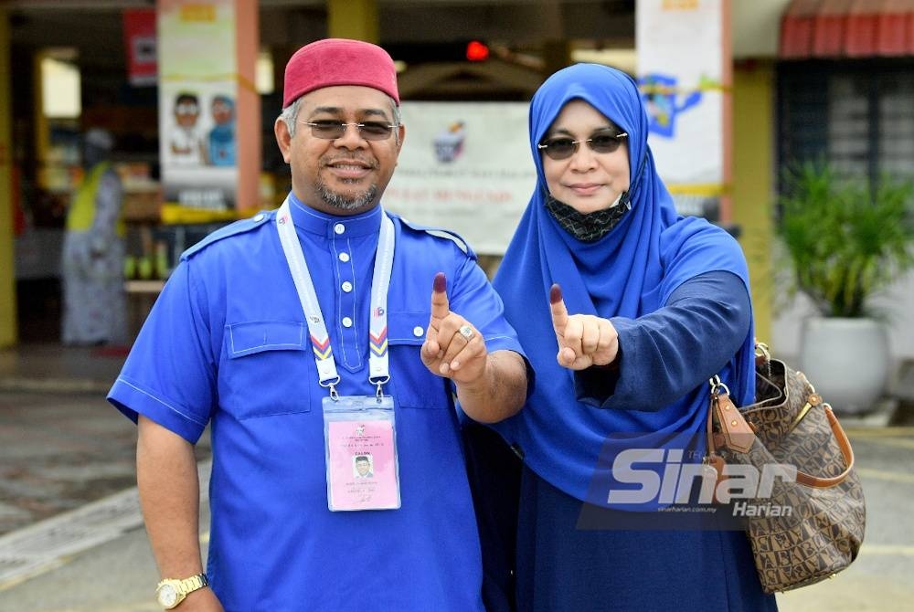 Khairuddin (kiri) bersama Anili selesai membuang undi jam 10.30 pagi di SMK Kompleks Seberang Takir pada Sabtu.