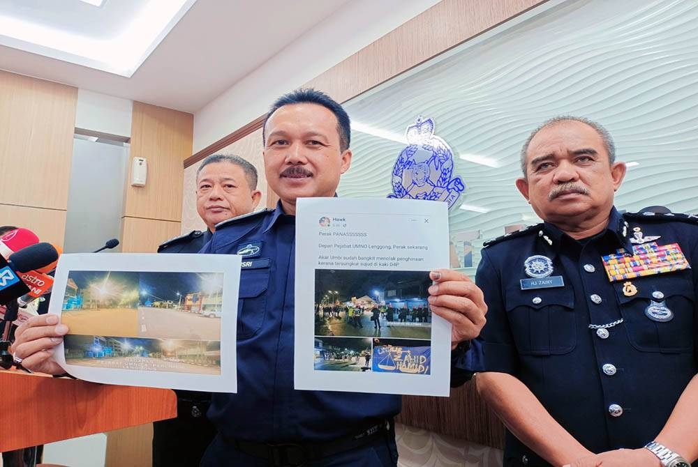 Mohd Yusri menunjukkan gambar-gambar yang tersebar di media sosial dakwaan berlaku rusuhan di Lenggong pada Isnin.