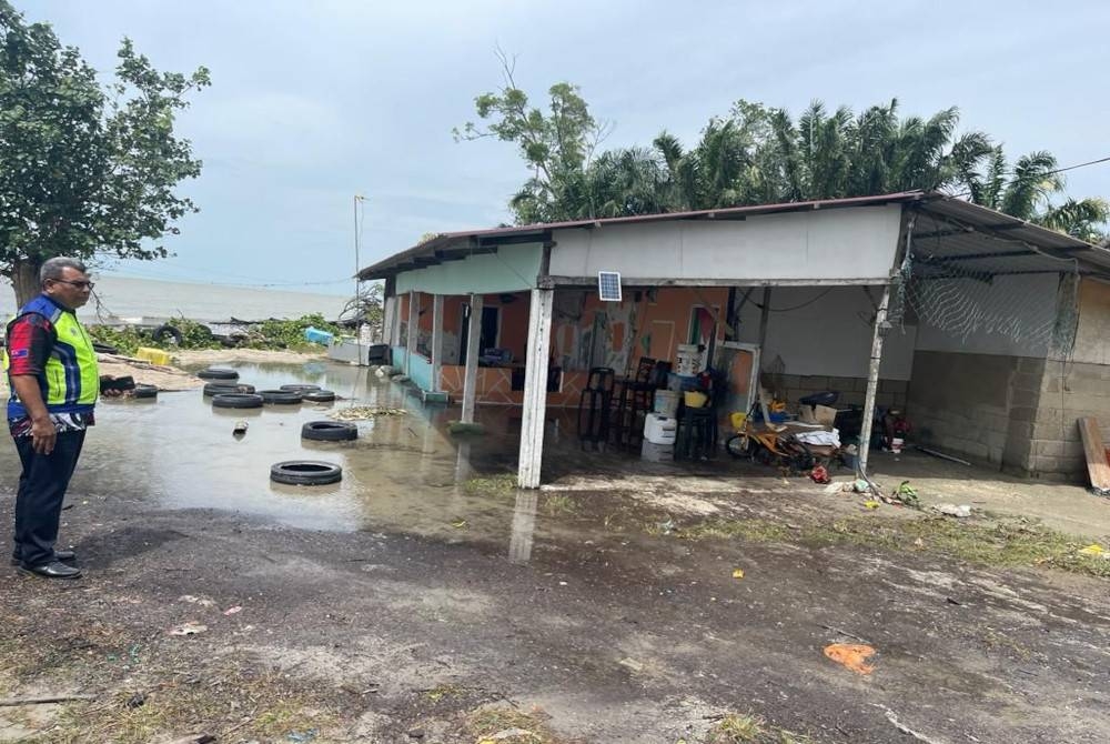 Anggota polis melakukan pemantauan di kawasan terjejas akibat air pasang besar di Parit Kedondong Laut dan Parit Jawa, Muar, pada Rabu.