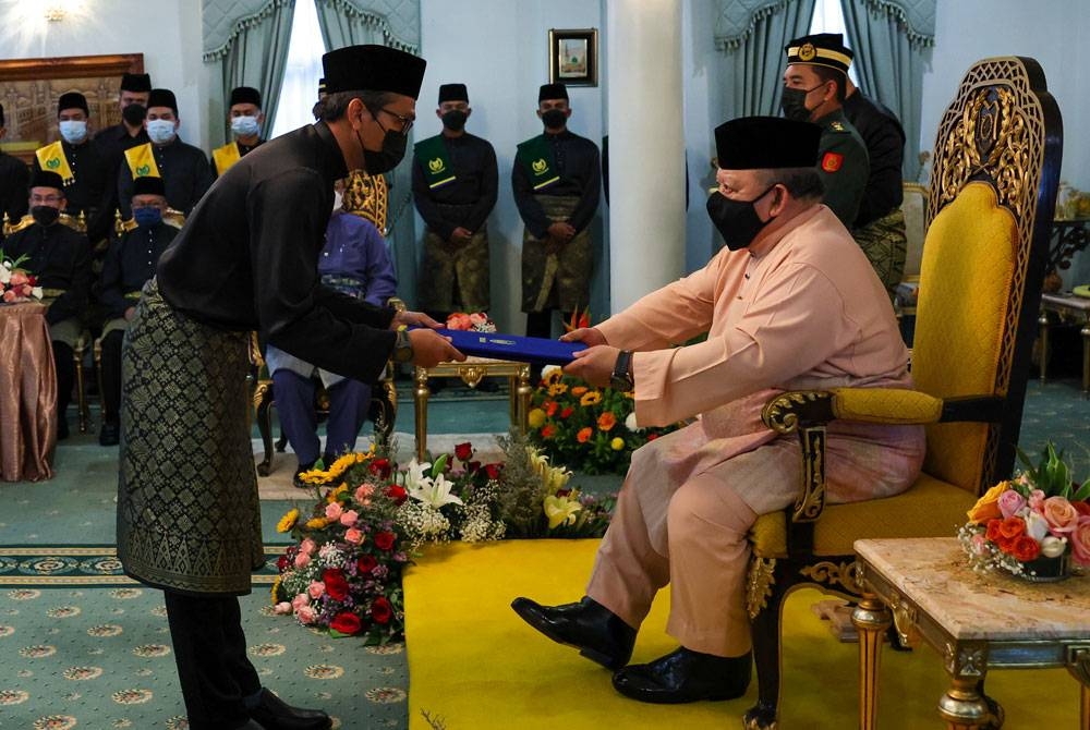 Raja Perlis, Tuanku Syed Sirajuddin Tuanku Syed Putra Jamalullail (kanan) berkenan menyampaikan watikah pelantikan kepada ADUN Titi Tinggi, Izizam Ibrahim sebagai Ahli Majlis Mesyuarat Kerajaan Negeri (Exco) di Istana pada Jumaat. -Foto: Bernama