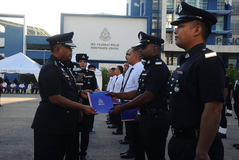 Kamarul Zaman menyampaikan sijil penghargaan kepada anggota pada Perhimpunan Bulanan Ketua Polis Johor di Dataran Kawad IPK Johor, pada Rabu.