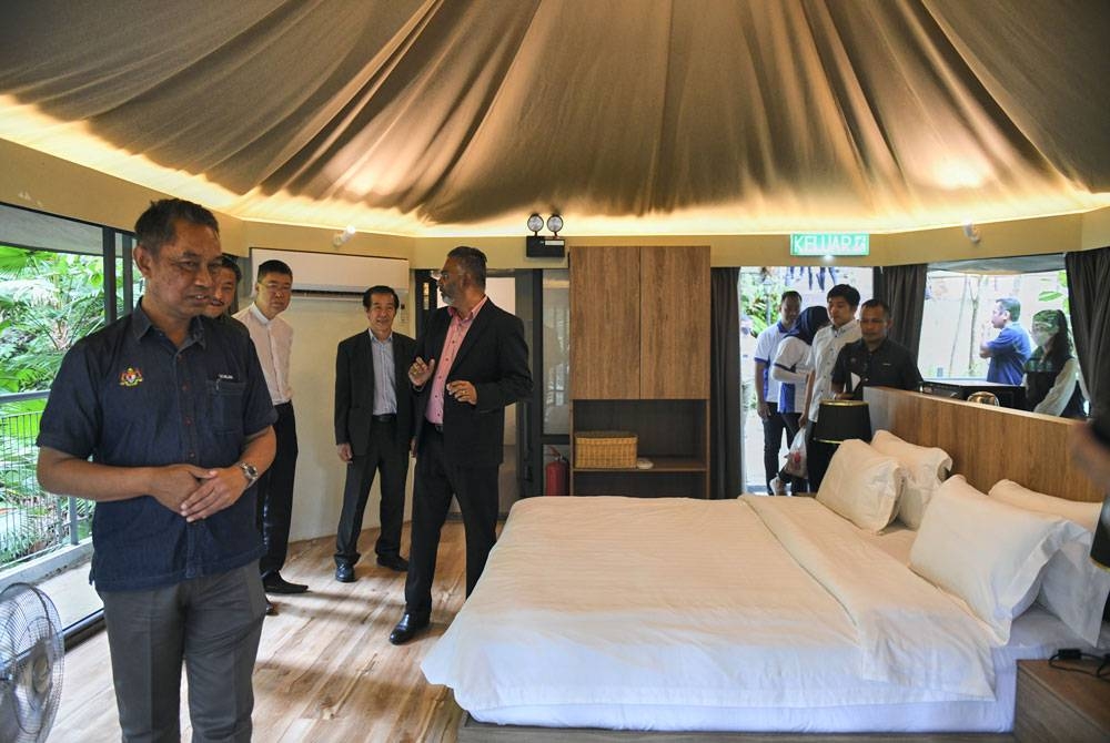 Setiausaha Bahagian Pelesenan dan Penguatkuasaan Pelancongan, Kementerian Pelancongan Roslan Mohammad (kiri) melawat bilik penginapan Boulder Valley Glamping, Teluk Bahang. - Foto Bernama.