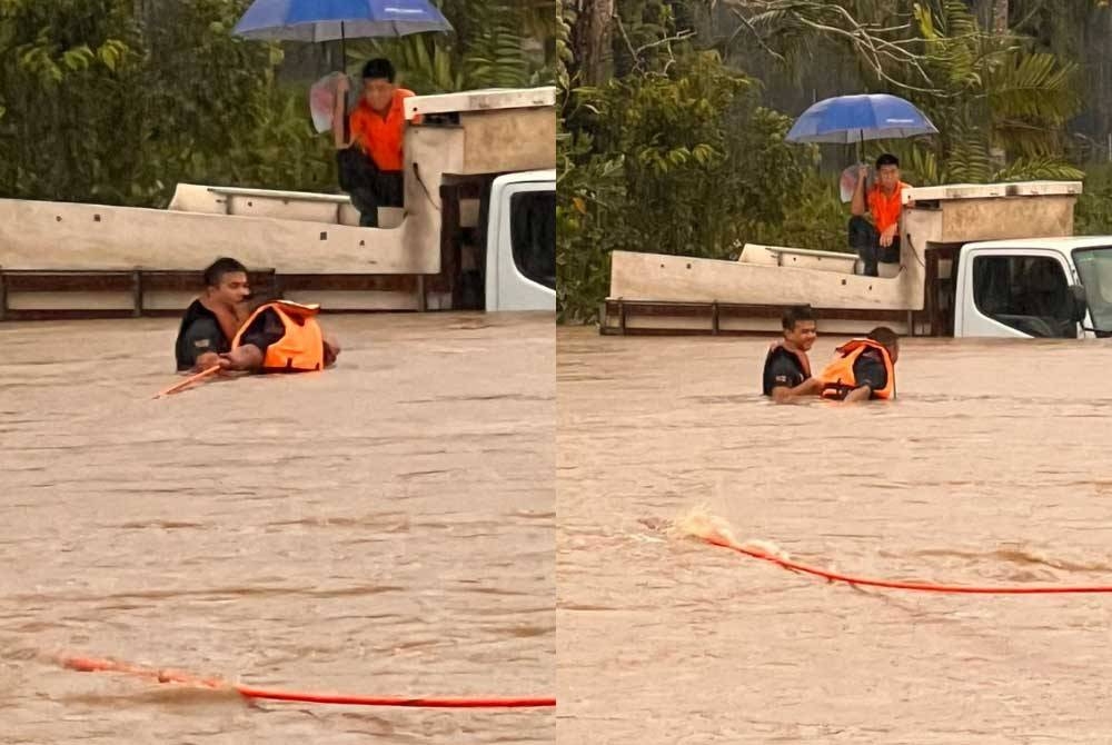 Anggota bomba membantu menyelamatkan pemandu lori yang terperangkap akibat banjir kilat di Sungai Lebam pada pagi Rabu. - Foto ihsan bomba