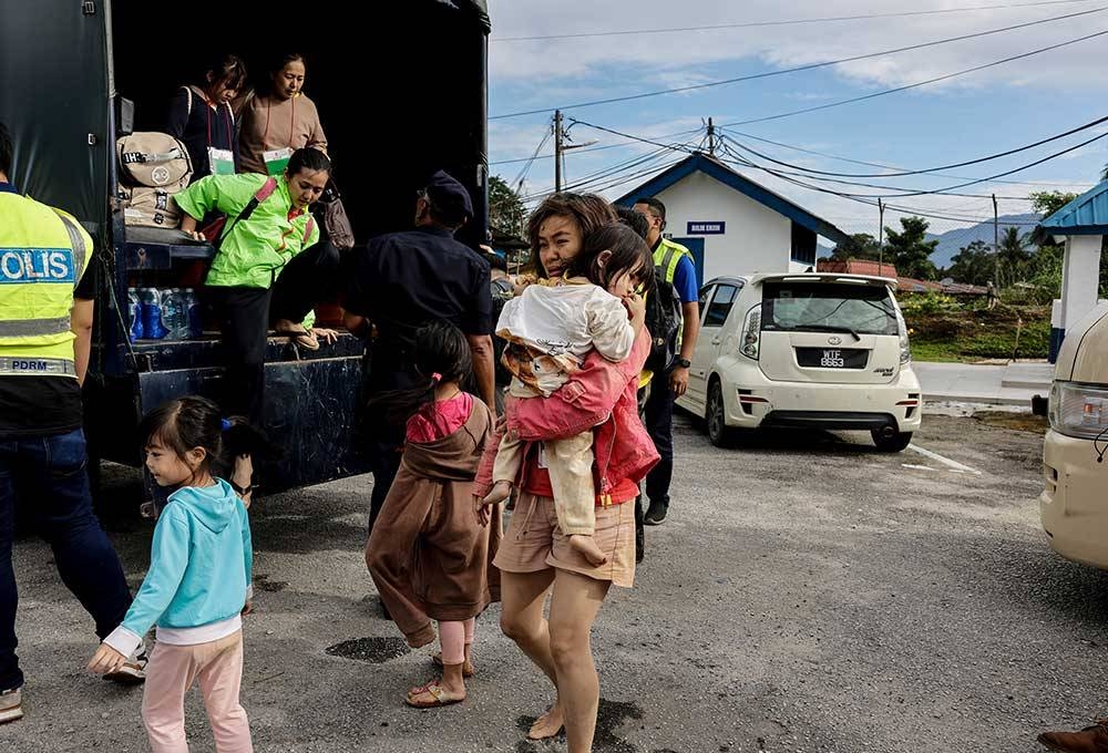 Antara mangsa tanah runtuh yang berjaya diselamatkan tiba di Balai Polis Hulu Yam Bharu selepas dibawa keluar daripada lokasi kejadian tanah runtuh di Father’s Organic Farm, Batang Kali pada Jumaat. - Foto Bernama