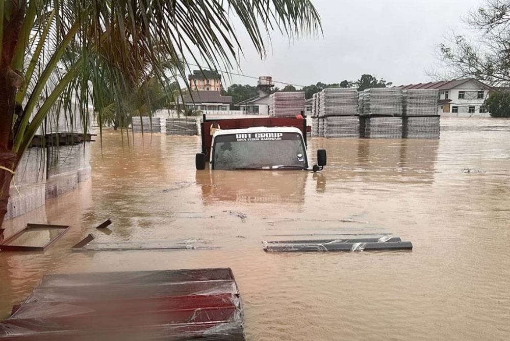 Lori dan simen milik Norizzuan ditenggelami air dalam banjir besar di Jalan Tandak.