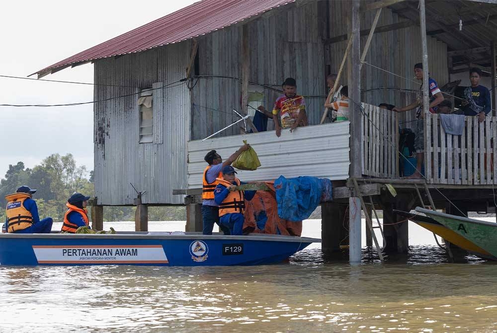 Badan bukan kerajaan (NGO) menyalurkan bantuan keperluan asas, makanan dan minuman kepada mangsa banjir. - Foto Bernama.