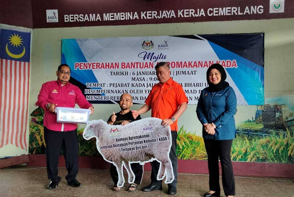 Mohamad (dua dari kanan) menyampaikan bantuan kepada peserta KADA pada Majlis Penyerahan Bantuan Agromakanan KADA pada Jumaat.