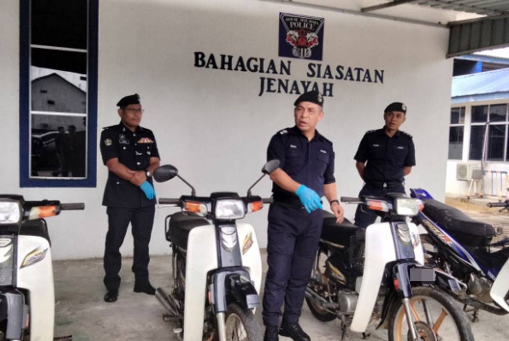 Mohd Haki (tengah) menunjukkan motosikal yang dicuri tiga suspek dalam dua serbuan berasingan sekitar Tanah Merah pada Selasa dan Rabu lalu.