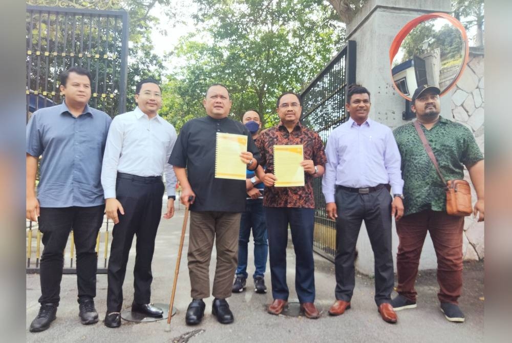 Mohd Sany (tiga dari kiri) dan Azli (tiga dari kanan) menunjukkan memorandum yang diserahkan kepada Sultan Selangor ketika ditemui di luar pekarangan Istana Alam Shah.