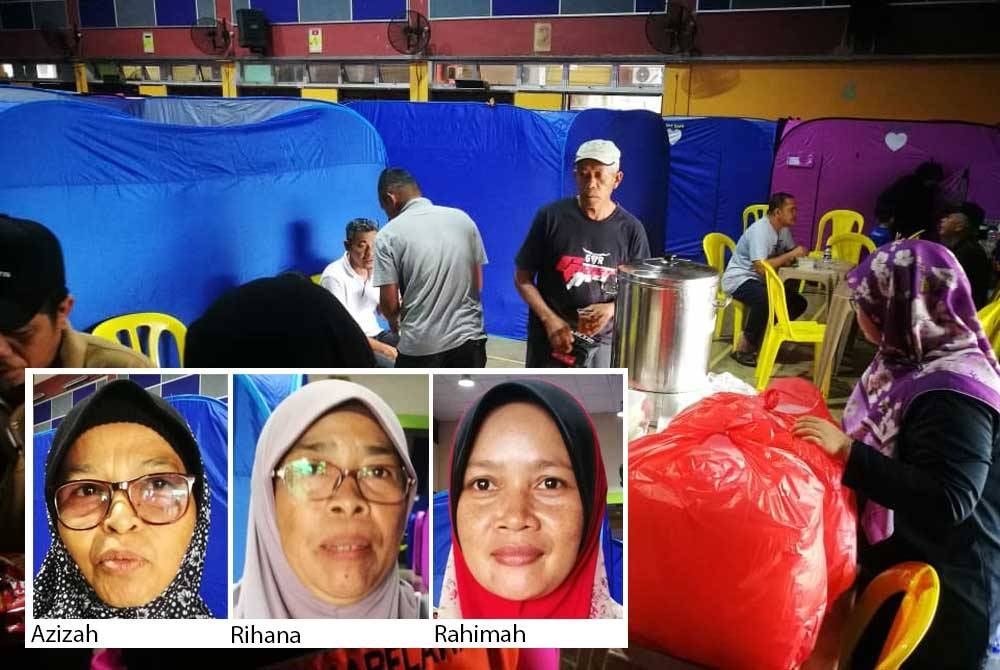 Mangsa banjir di PPS SMK Sultan Abdul Jalil mengambil juadah makan tengah hari disediakan pada Khamis.