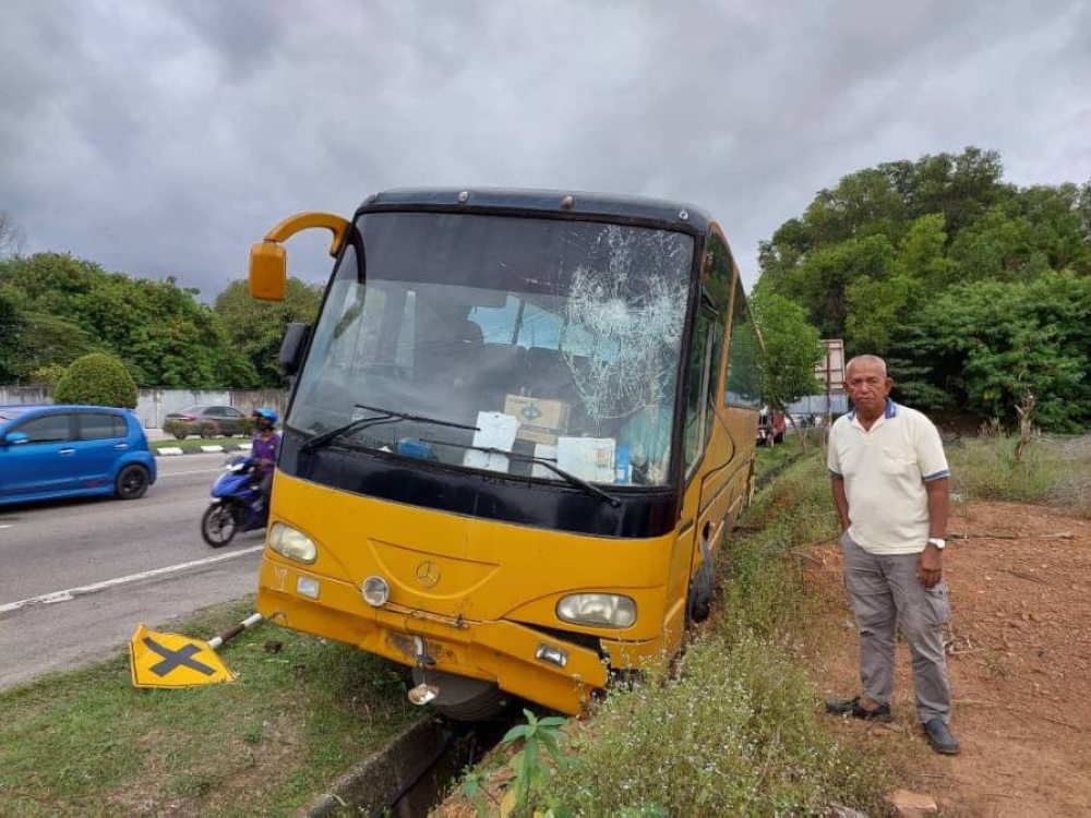 Bas sekolah yang dilarikan seorang lelaki sebelum terbabas di tepi Lebuh AMJ berdekatan Taman Malinja.