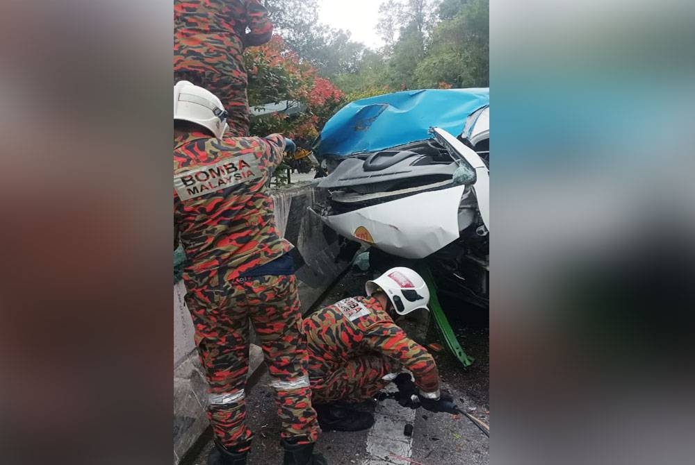 Anggota bomba membantu mengeluarkan penumpang tersepit dalam kemalangan di KM 4.8 Jalan Genting Highlands pada Rabu.