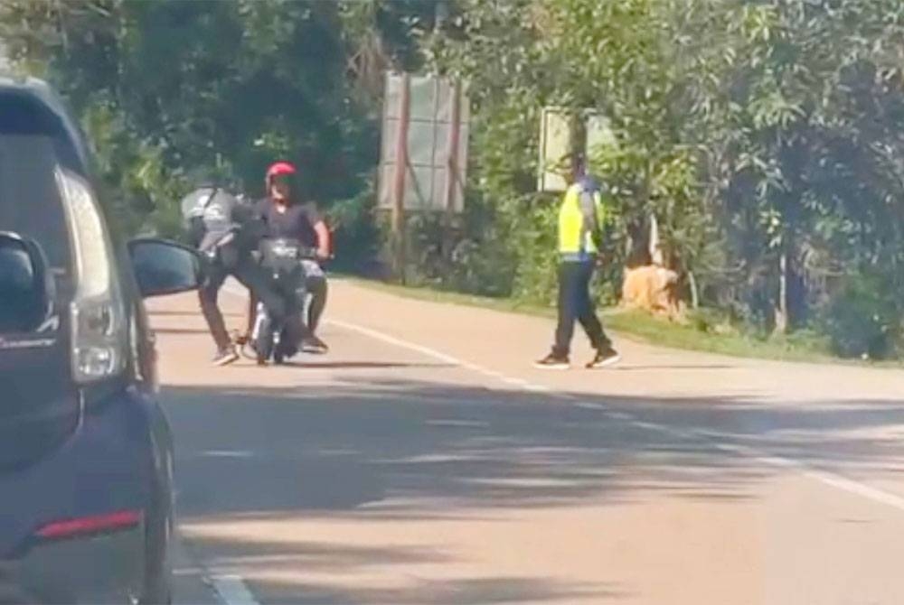 Suspek (kiri) membuat pusingan &#039;U&#039; selepas melihat SJR Op Bersepadu di Jalan Pasir Mas - Rantau Panjang, berhampiran Taman Tengku Anis namun hilang kawalan dan melanggar anggota polis yang sedang bertugas.