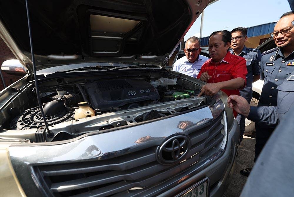 Ahmad melihat antara kenderaan yang berjaya dirampas kerana terlibat dengan penyeludupan diesel ketika mengadakan lawatan ke Stor Penguatkuasaan Jabatan Kastam Diraja Malaysia pada Ahad. - Foto Bernama