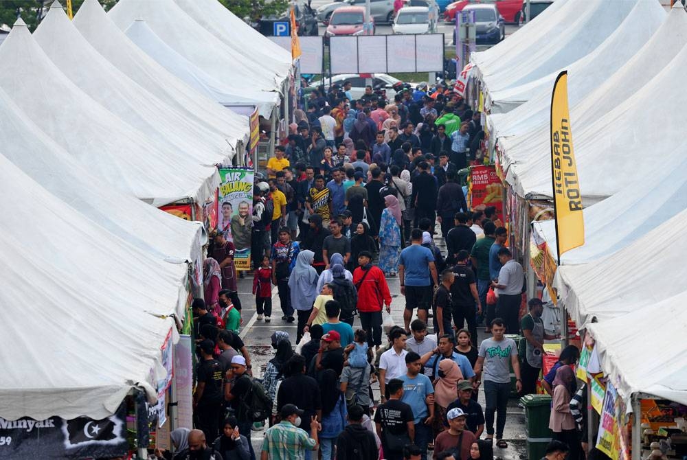 Orang ramai mengunjungi Bazar Ramadan Presint 3, Putrajaya bagi membeli juadah berbuka puasa hari pertama umat Islam menyambut ibadah puasa. - Foto Bernama