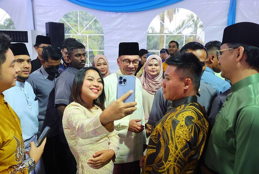 Perdana Menteri Datuk Seri Anwar Ibrahim (tengah) beramah mesra dengan para tetamu pada Majlis Iftar Perdana Menteri Bersama Golongan Belia anjuran bersama Kementerian Pendidikan Tinggi dan Kementerian Belia dan Sukan di Kompleks Seri Perdana malam ini. - Foto Bernama.