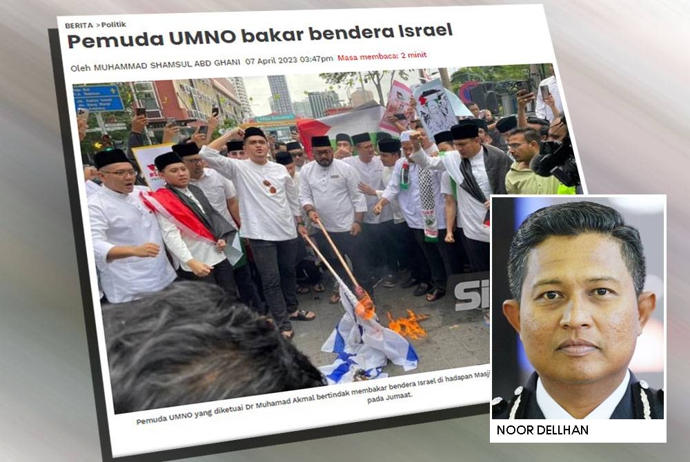 Pemuda UMNO pada Jumaat, membakar bendera Israel sebagai tanda solidariti terhadap umat Palestin semasa Himpunan Solidariti Bersama Palestin di Masjid Jamek, Kampung Baru.