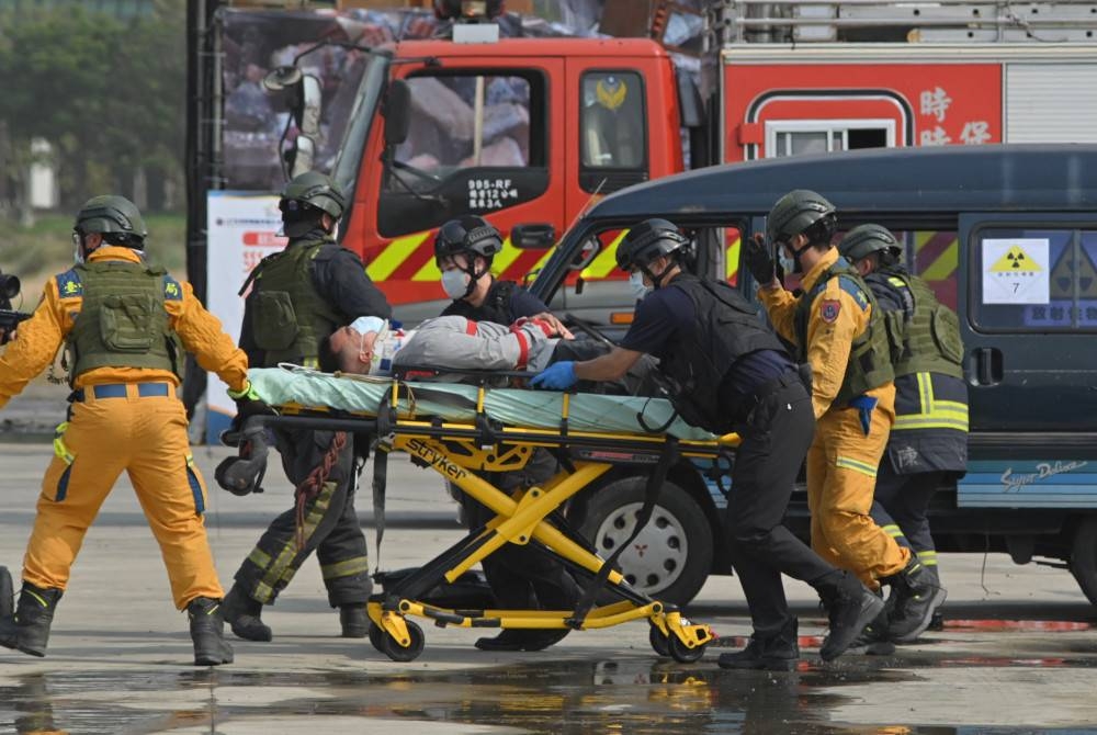 Anggota penyelamat mengusung &#039;mangsa cedera&#039; ketika latihan olok-olok menghadapi serangan China. - Foto AFP