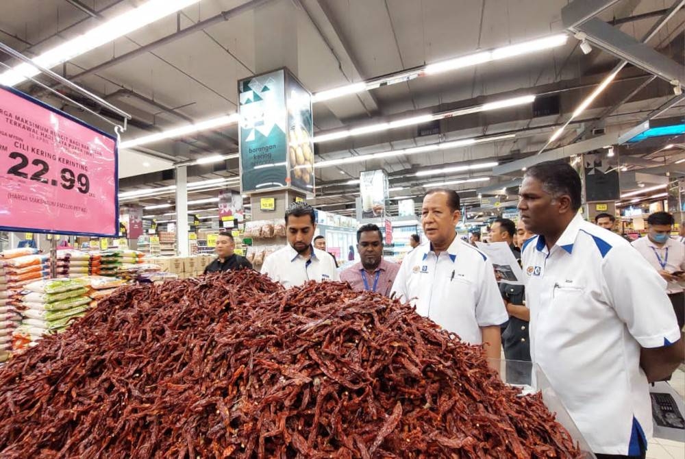 Jegan (kanan) mengiringi Abdul Halim (dua dari kanan) meninjau harga barang di Pasaraya Mydin Bukit Mertajam pada Selasa.