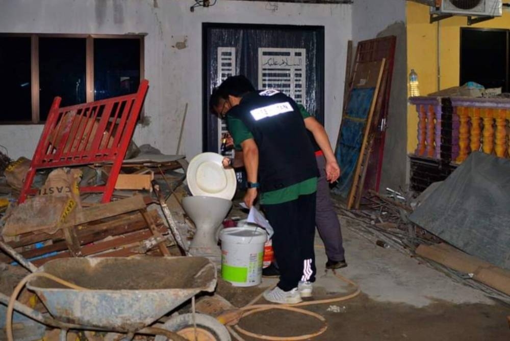 Pegawai JKNP melakukan pemeriksaan tempat pembiakan waktu malam di kawasan wabak demam denggi berulang di Taman Pasdec Makmur di sini minggu lalu. Foto FB PKD Kuantan