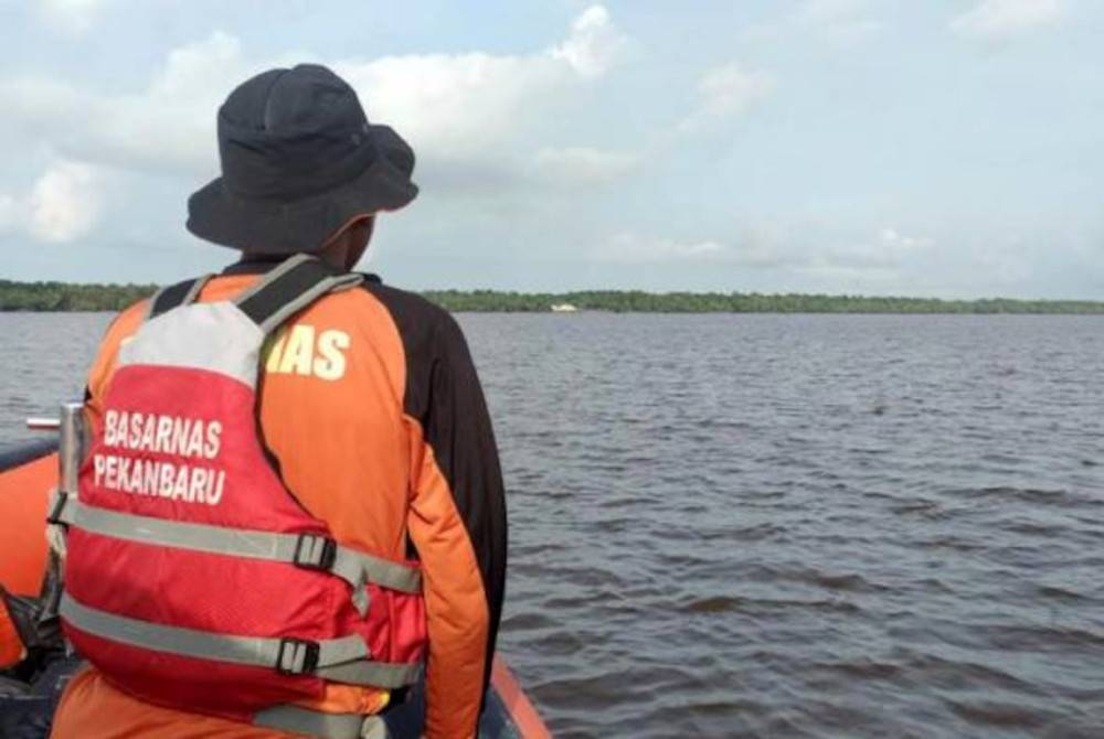 Seorang anggota penyelamat meninjau keadaan di laut dalam operasi mencari dan menyelamat mangsa bot laju yang karam di Kabupaten Indragiri Hilir, Indonesia, 28 April 2023. - Foto AP