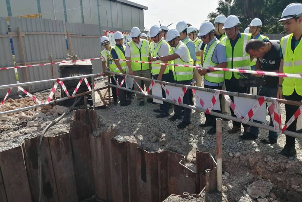 Izham (empat dari kiri) meninjau progres sistem agihan dan kolam menara di bawah Skim Bekalan Air Labohan Dagang Fasa 1 di Telok Panglima Garang pada Sabtu.