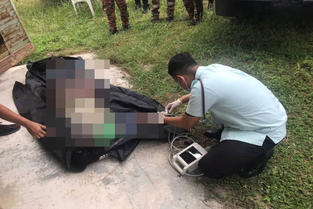 Pasukan perubatan melakukan pemeriksaan sebelum mengesahkan mangsa meninggal dunia di tempat kejadian. - Foto Ihsan JBPM Perak