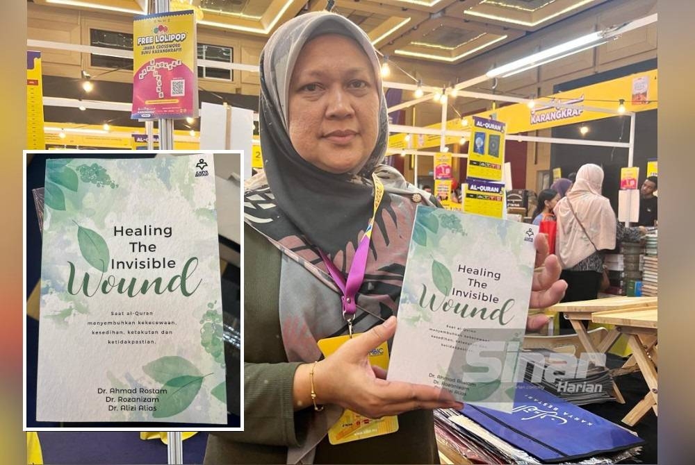 Roziyana menunjukkan buku &#039;Healing The Invisible Wound&#039; yang dijual di reruai Kumpulan Karangkraf sempena PBAKL di WTC.