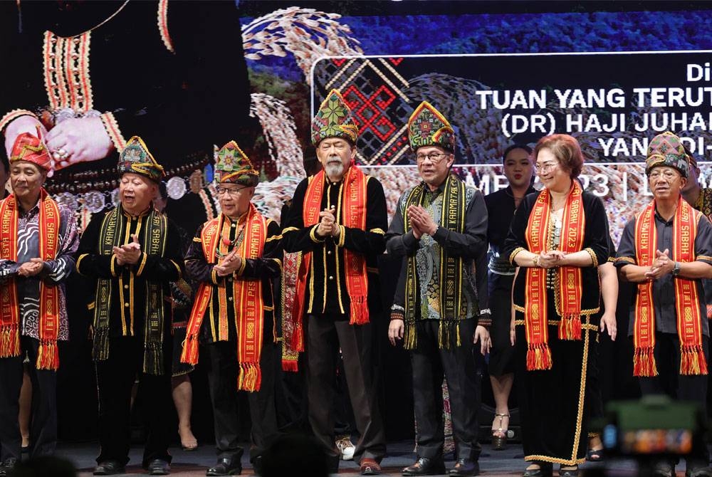 Anwar (tiga, kanan) turut menyanyikan lagu Tadau Kaamatan pada majlis penutupan sambutan Pesta Kaamatan Peringkat Negeri Sabah di Dewan Hongkod Koisaan Kadazan Dusun Cultural Association (KDCA) Penampang pada Rabu. - Foto: Bernama