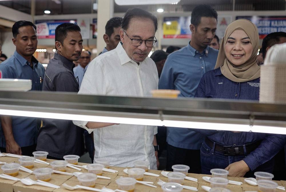 Anwar melihat pelbagai juadah makanan di medan selera pada majlis perasmian D&#039;Anjung Selera Madani Jalan Jujur, Bandar Tun Razak pada Sabtu. - Foto Bernama