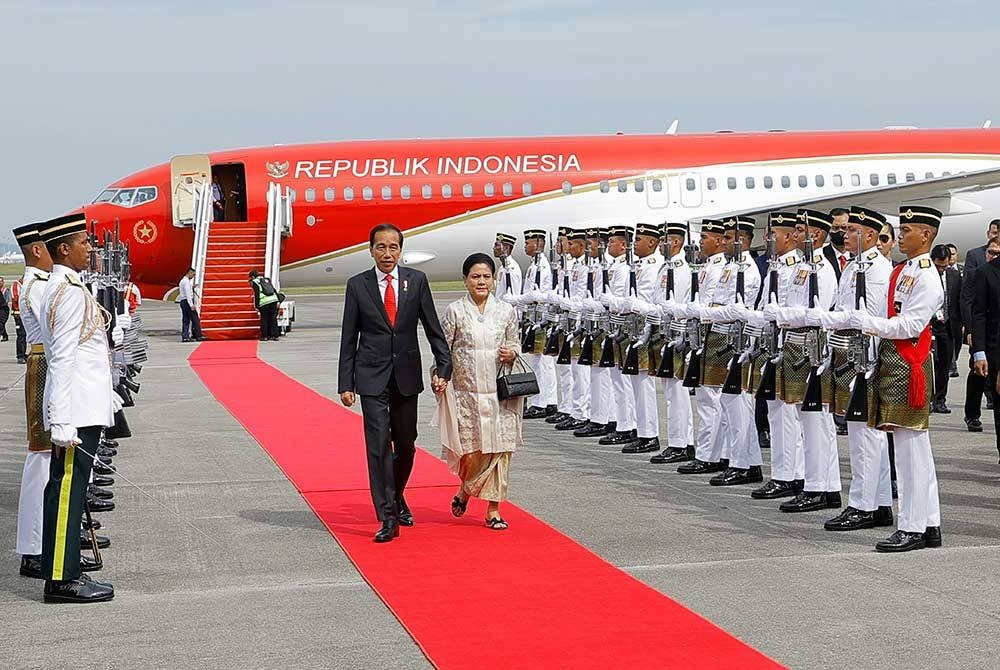 Presiden Indonesia Joko Widodo dan isteri Iriana Joko Widodo memeriksa kawalan kehormatan setempat sebaik tiba di Kompleks Bunga Raya Lapangan Terbang Antarabangsa Kuala Lumpur (KLIA) hari ini sempena lawatan kerja dua hari di Malaysia. - Foto Bernama