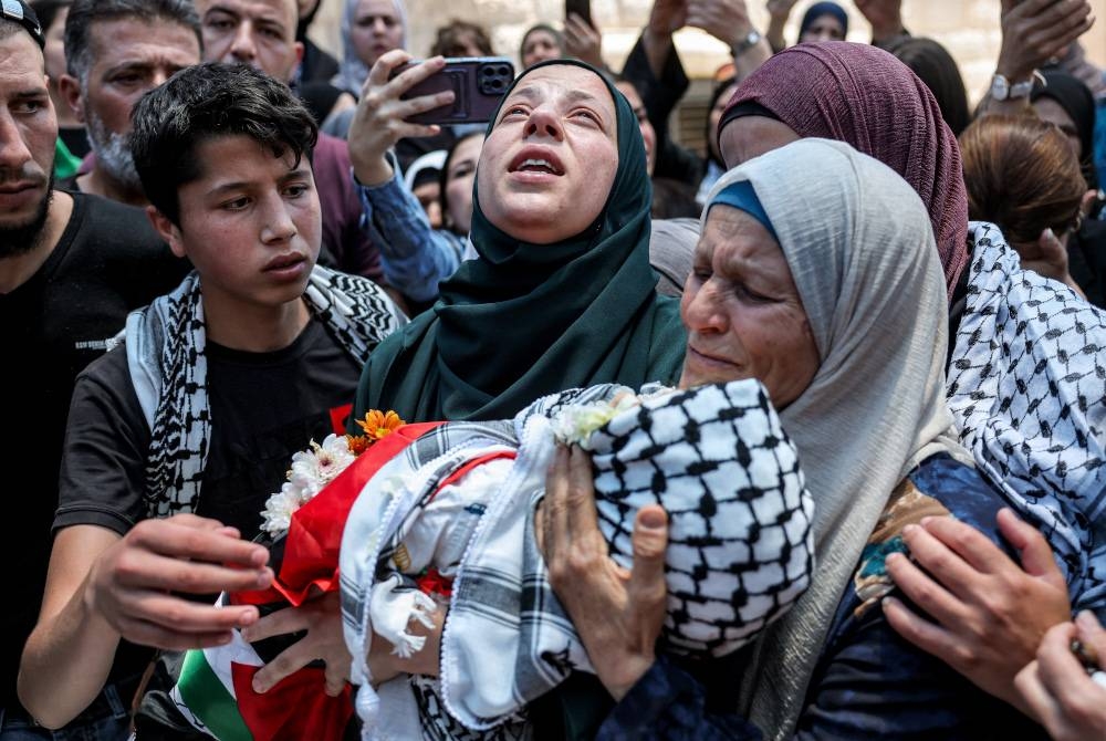 Seorang ibu meratapi kematian anaknya berusia tiga tahun yang ditembak mati oleh tentera Israel di Tebing Barat. - AFP