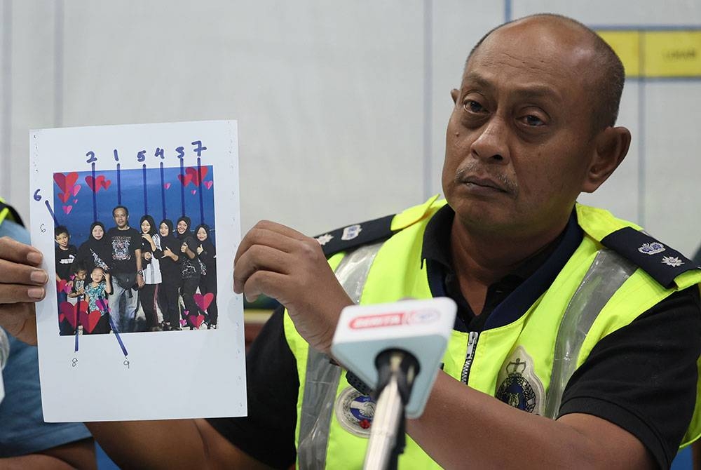 Hanyan menunjukkan gambar sembilan mangsa yang terlibat dalam kejadian kepala air di Jeram Air Putih, Kampung Air Putih pada sidang media di Ibu Pejabat Polis Daerah Kemaman, pada Ahad malam. - Foto Bernama