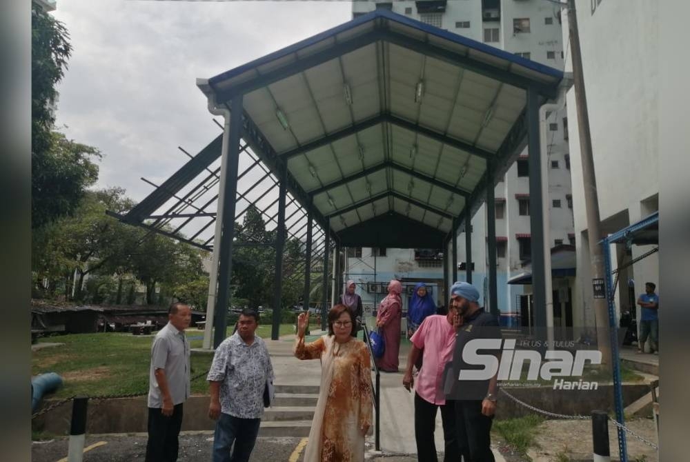 Yee Kew (tengah) menunjukkan dewan serbaguna di bawah projek ICU untuk kegunaan penduduk Flat Danau Kota.