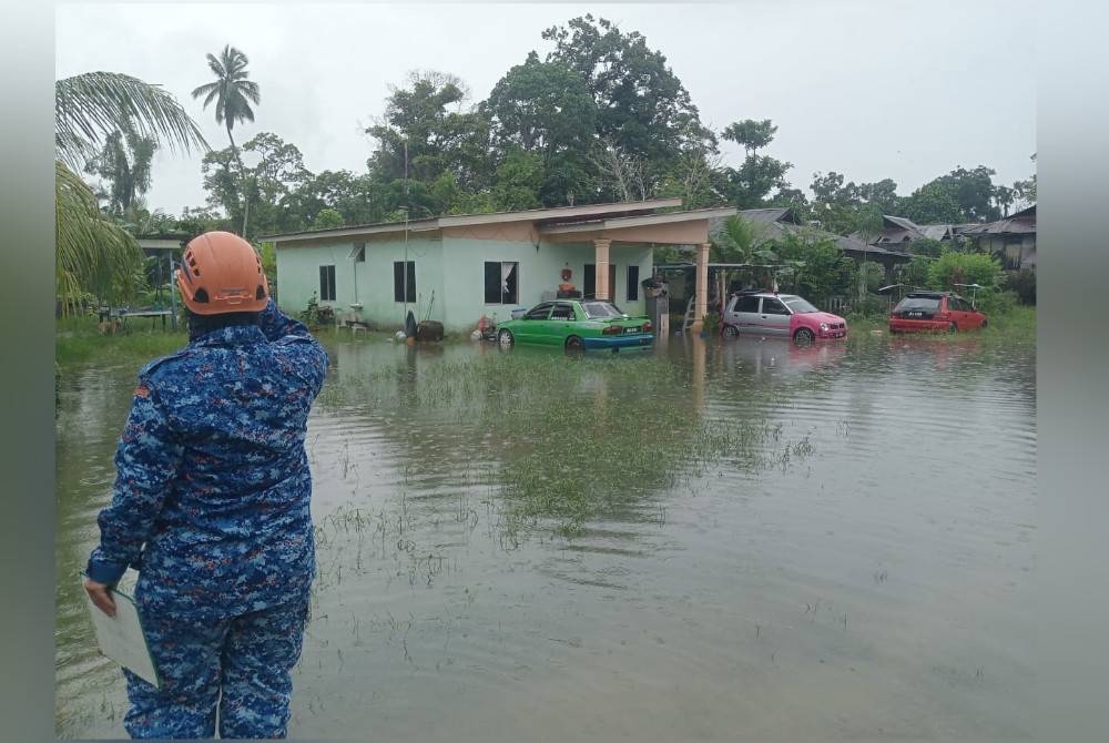 Anggota APM melakukan pemantauan di Kampung Serkat Pontian yang dinaiki air ekoran air pasang dan hujan lebat pada petang Selasa.