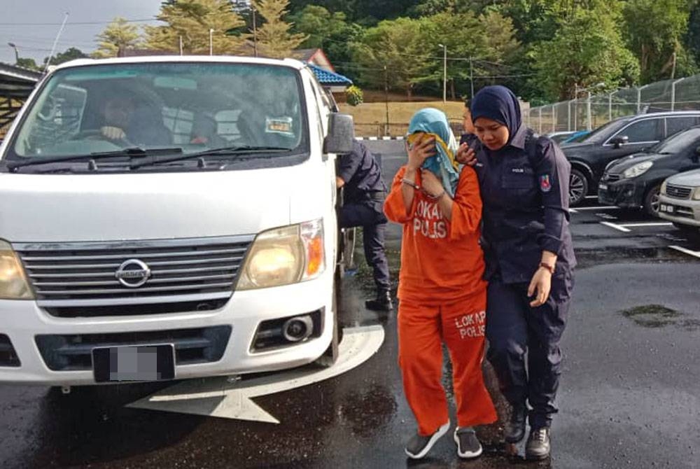 Hafeeza Syuhada diiring polis ketika hadir di Mahkamah Kuala Pilah pada Jumaat