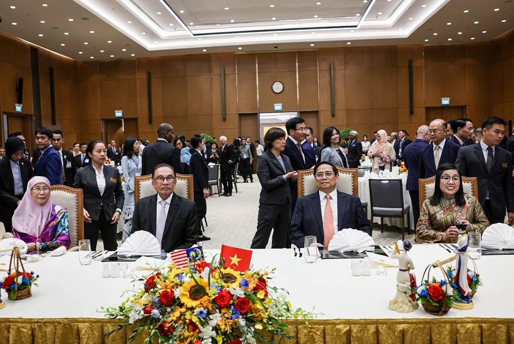 Anwar (dua dari kiri) dan isteri, Wan Azizah (kiri) bersama rakan sejawatnya Pham Minh Chinh (dua dari kanan) dan isteri, Le Thi Bich Tran pada majlis makan malam sempena lawatan Perdana Menteri ke Vietnam di The Presidential Palace pada Khamis. - Foto Bernama