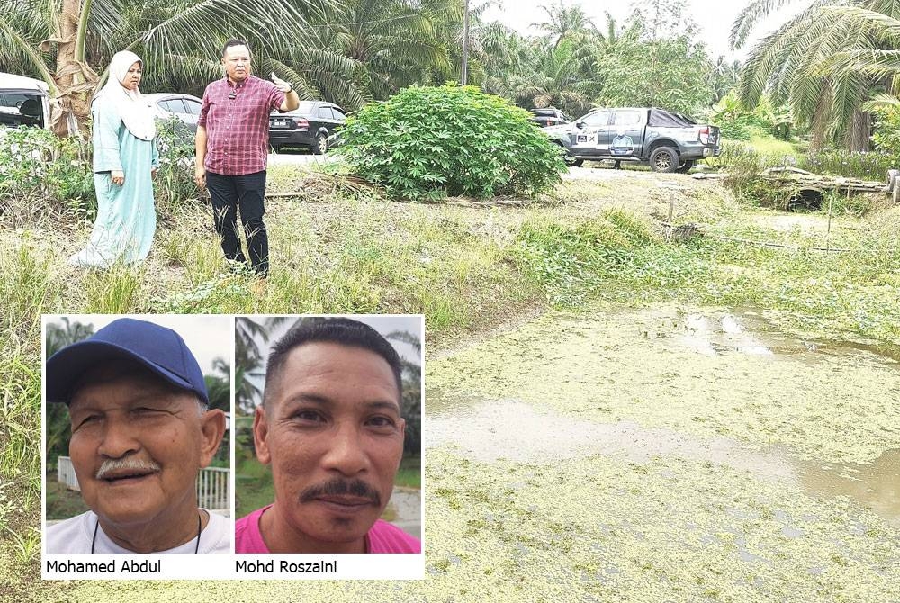 Rizam dan Sawiah meninjau parit yang sering mengakibatkan limpahan banjir di Kampung Batu 38 Baroh di sini pada Isnin.