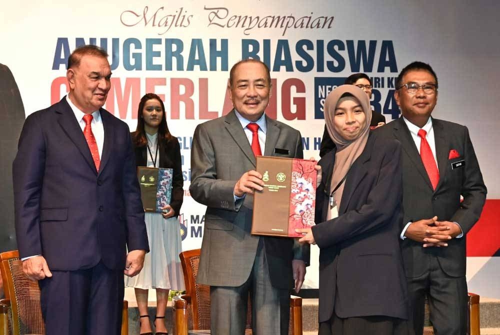 Hajiji menyampaikan anugerah cemerlang kepada salah seorang pelajar pada Majlis Penyampaian Anugerah Biasiswa Cemerlang Negeri Sabah Siri ke-34 di Auditorium Tun Ahmad Raffae, Menara Tun Mustapha Kota Kinabalu.